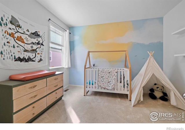 carpeted bedroom featuring visible vents and baseboards