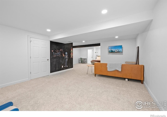 carpeted living area featuring baseboards and recessed lighting