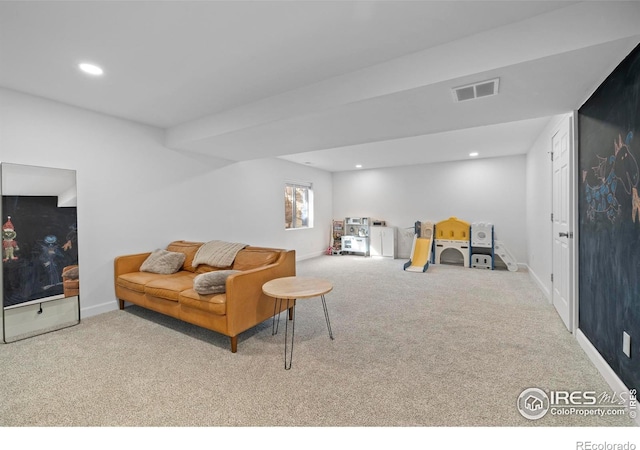 carpeted living area featuring visible vents, baseboards, and recessed lighting