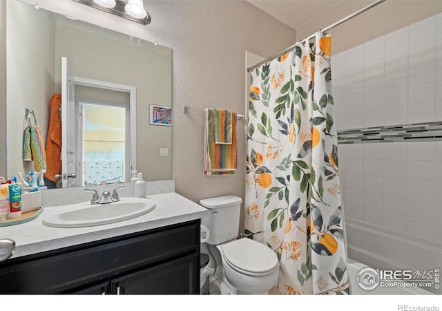 bathroom featuring toilet, shower / tub combo, vanity, and a textured wall