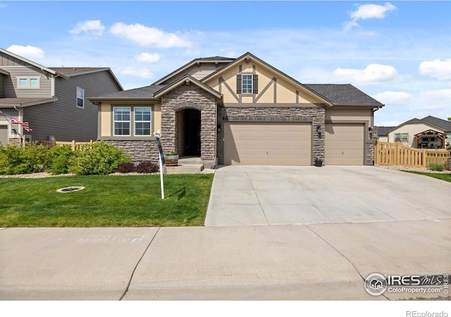 5219 Odessa Lake St, Timnath, CO 80547 - view of front of property with stone siding, stucco siding, a garage, and concrete driveway