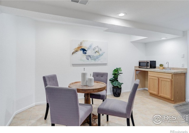 dining area featuring baseboards, recessed lighting, and light tile patterned flooring