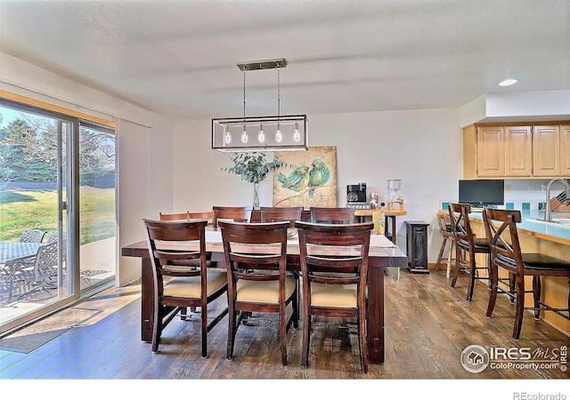 dining room with recessed lighting and dark wood-style flooring