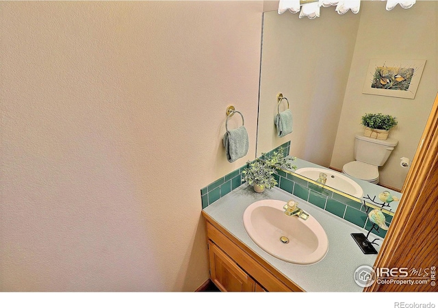 half bath with vanity and toilet