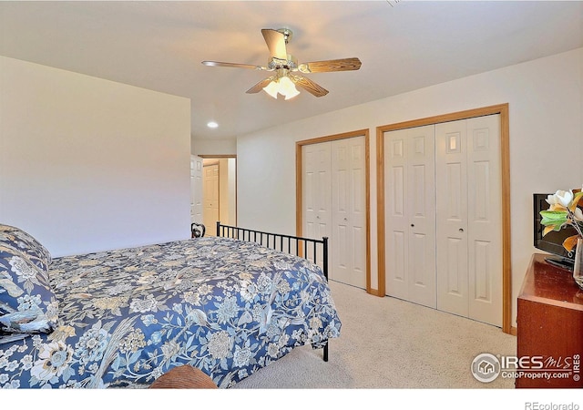 carpeted bedroom with recessed lighting, multiple closets, and ceiling fan