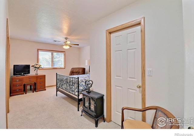 bedroom featuring visible vents, ceiling fan, and carpet