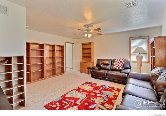 carpeted living room featuring visible vents and ceiling fan