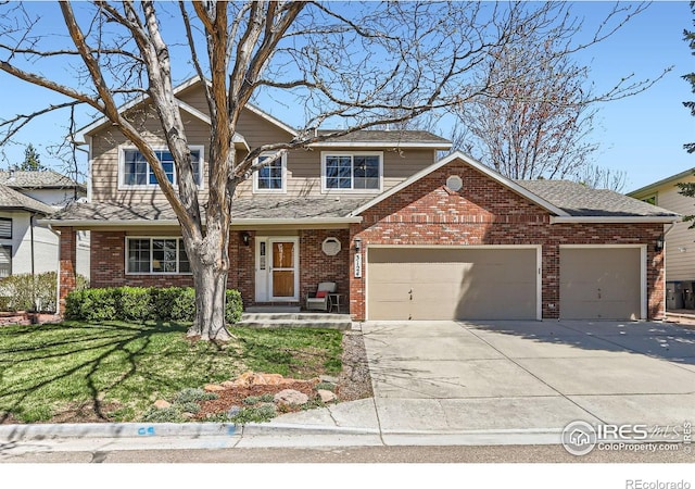 traditional-style house with brick siding, driveway, a garage, and a front lawn