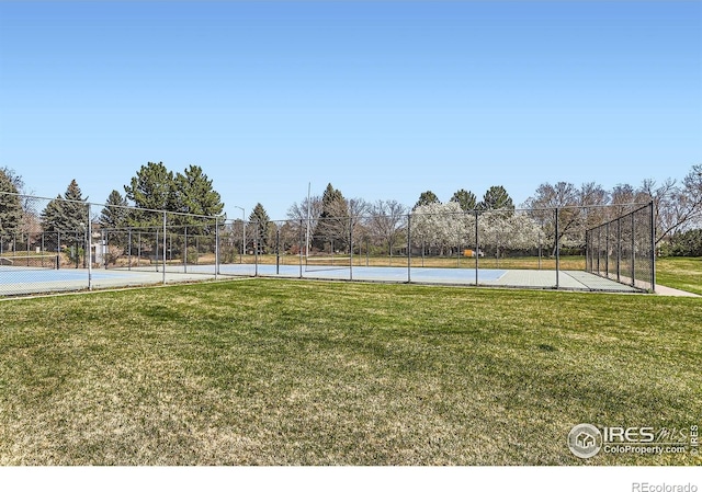 exterior space featuring fence and a lawn