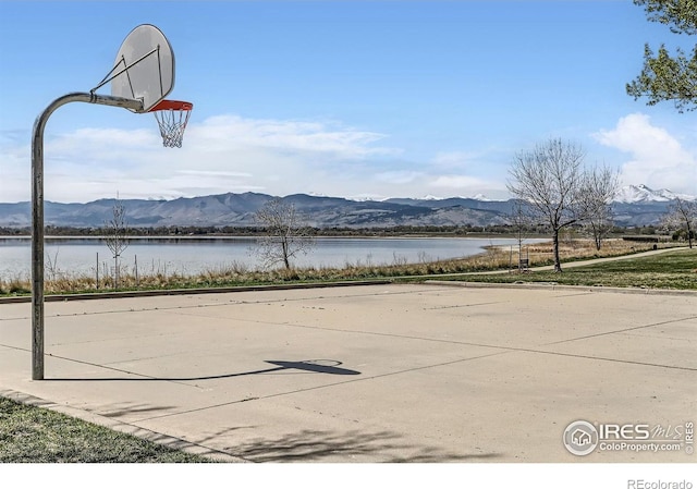 view of sport court with community basketball court and a water and mountain view