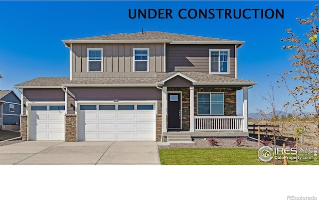 1898 Westport Ave, Berthoud, CO 80513 - traditional home featuring driveway, board and batten siding, stone siding, a garage, and covered porch