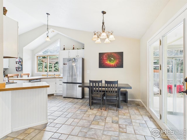 kitchen featuring a sink, white cabinetry, lofted ceiling, and stainless steel appliances