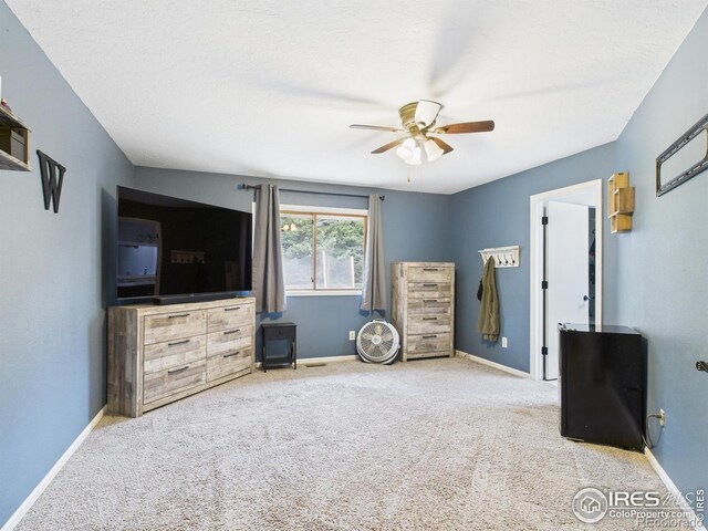 interior space with baseboards and a ceiling fan