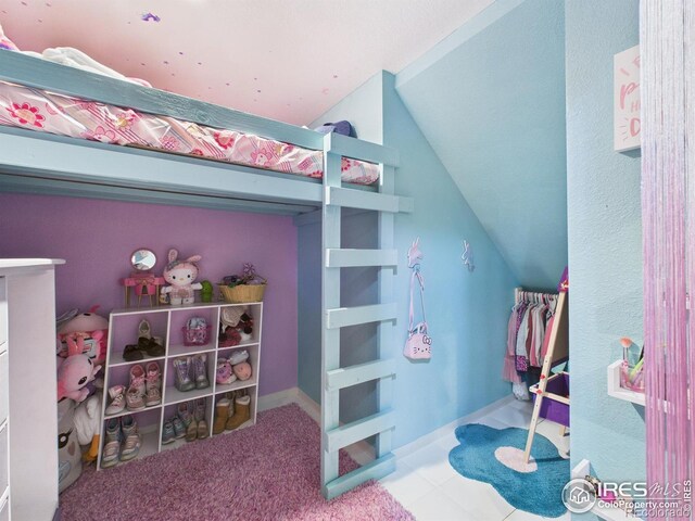 bedroom featuring vaulted ceiling