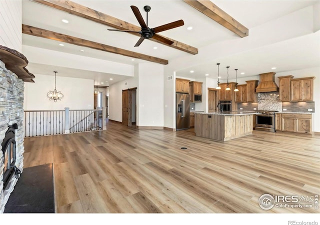 unfurnished living room featuring light wood-style flooring, ceiling fan with notable chandelier, beamed ceiling, and recessed lighting