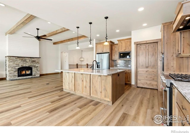 kitchen featuring a ceiling fan, beamed ceiling, light wood finished floors, premium range hood, and appliances with stainless steel finishes