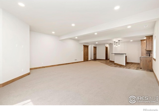 unfurnished living room with light carpet and recessed lighting