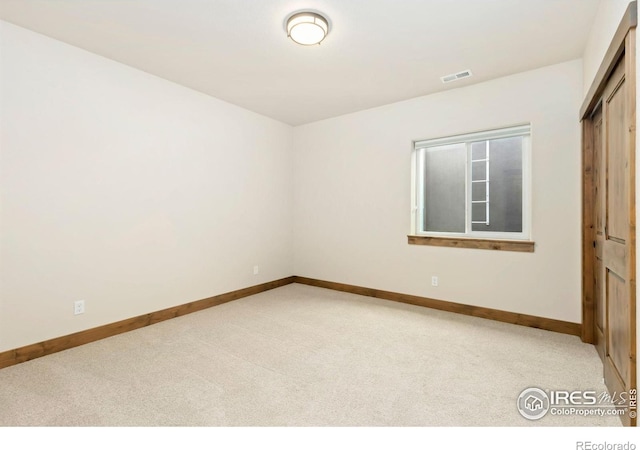 unfurnished bedroom featuring a closet, visible vents, baseboards, and carpet