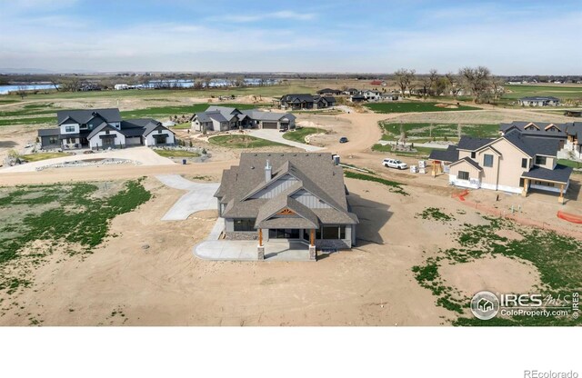 drone / aerial view with a residential view and a water view