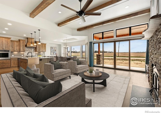 living room with recessed lighting, light wood-type flooring, and beam ceiling
