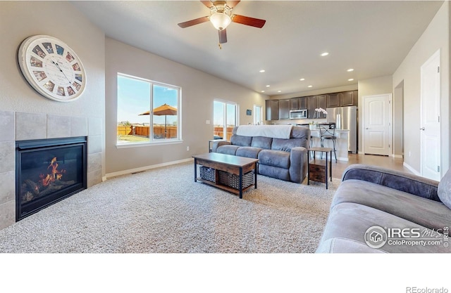 living area with ceiling fan, a fireplace, baseboards, visible vents, and recessed lighting