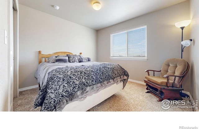 carpeted bedroom featuring baseboards