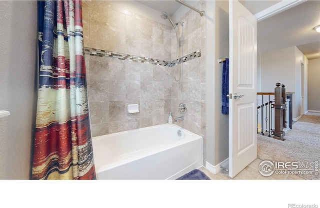full bathroom featuring shower / tub combo and baseboards
