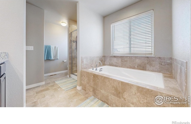 full bathroom featuring a shower stall and a bath