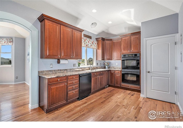 kitchen with recessed lighting, light wood finished floors, a sink, baseboards, and black appliances