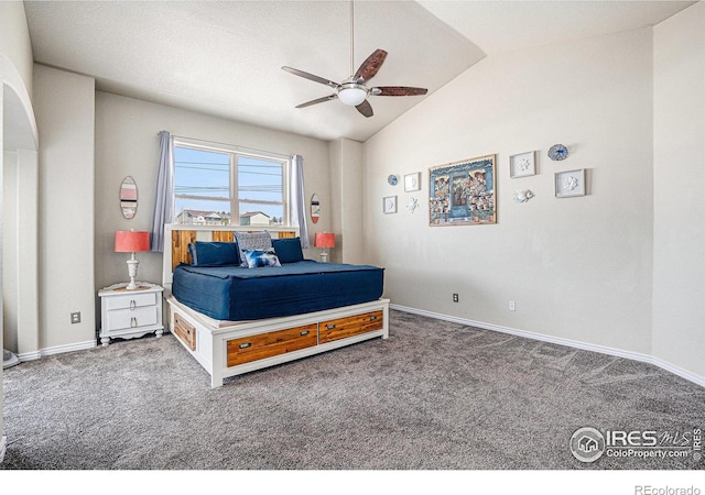 carpeted bedroom featuring vaulted ceiling, baseboards, and ceiling fan
