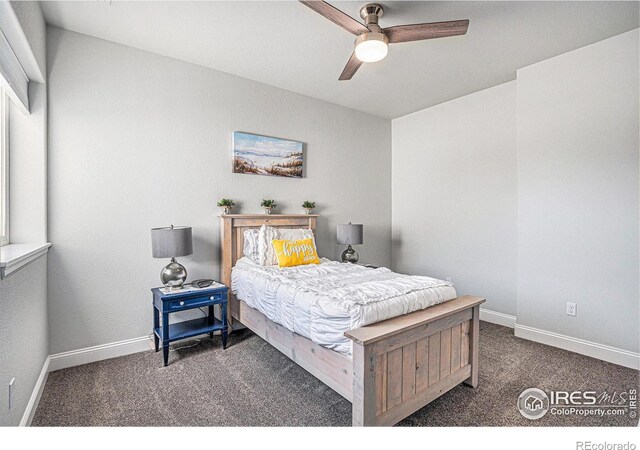 carpeted bedroom featuring baseboards and a ceiling fan