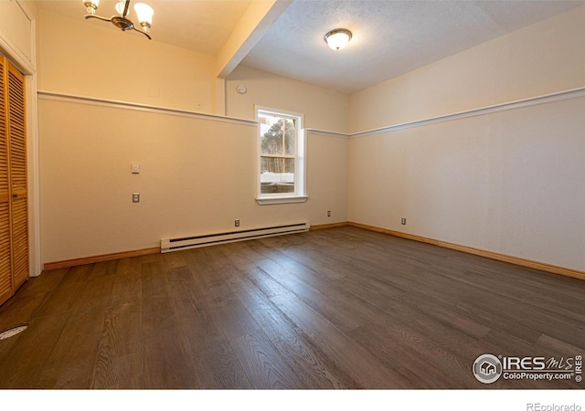 spare room with baseboards, wood finished floors, a notable chandelier, and a baseboard radiator