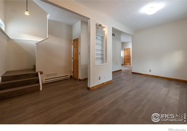 interior space featuring a baseboard heating unit, baseboards, stairs, and dark wood-style floors
