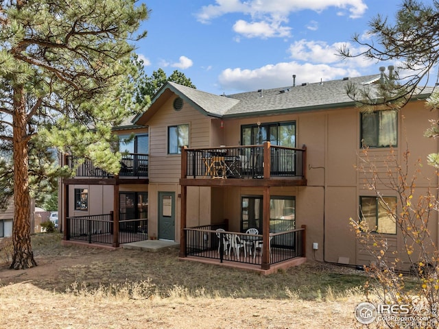 1155 S Saint Vrain Ave Unit 1-3, Estes Park, CO 80517 - rear view of property with a patio area, a balcony, and a shingled roof