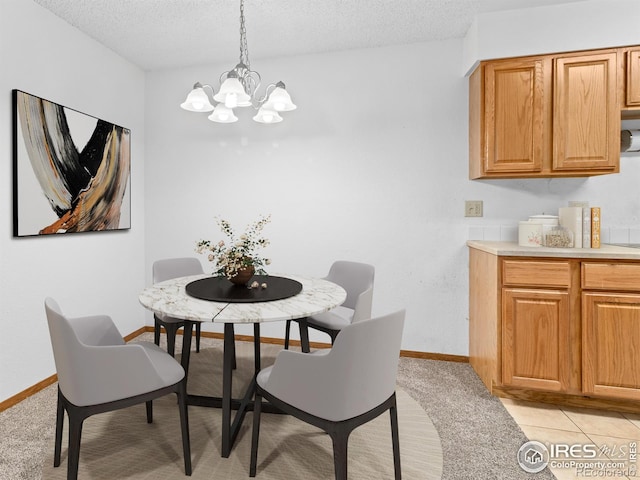 1155 S Saint Vrain Ave Unit 1-3, Estes Park, CO 80517 - dining area with baseboards, an inviting chandelier, a textured ceiling, and light colored carpet
