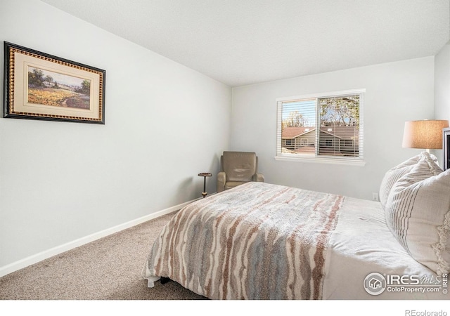carpeted bedroom with baseboards