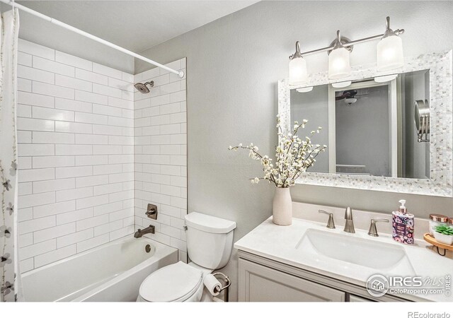 full bath featuring toilet, vanity, and shower / bathing tub combination