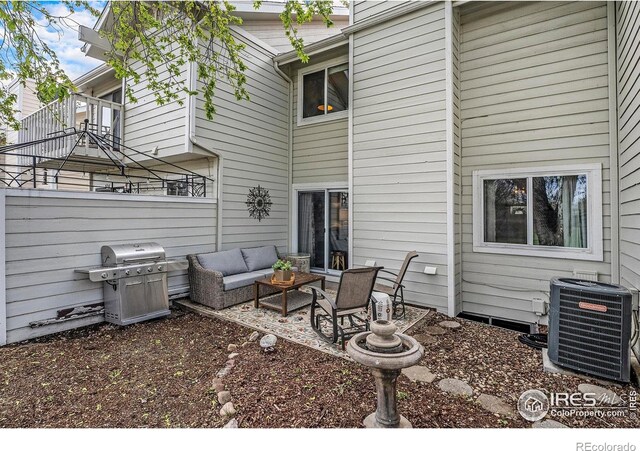 rear view of house with central air condition unit, an outdoor living space, and a patio area