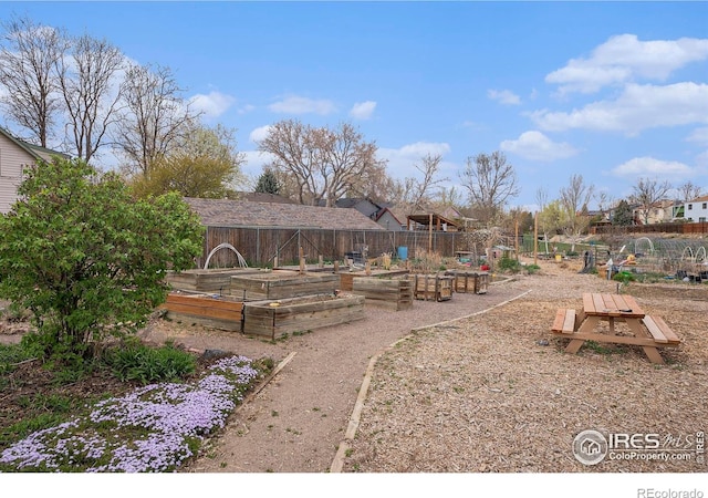 exterior space featuring a vegetable garden and fence