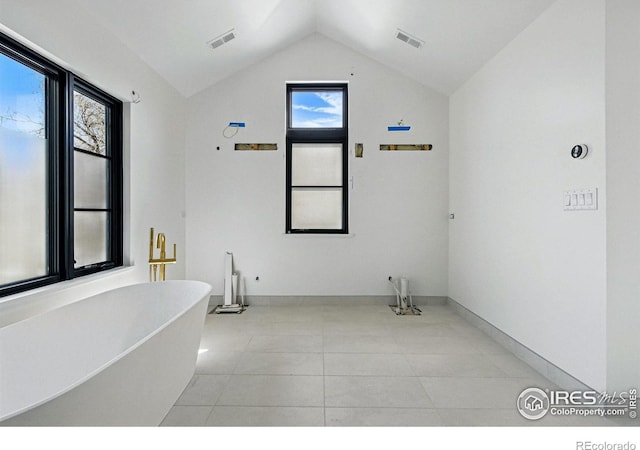 bathroom with vaulted ceiling, visible vents, and a healthy amount of sunlight