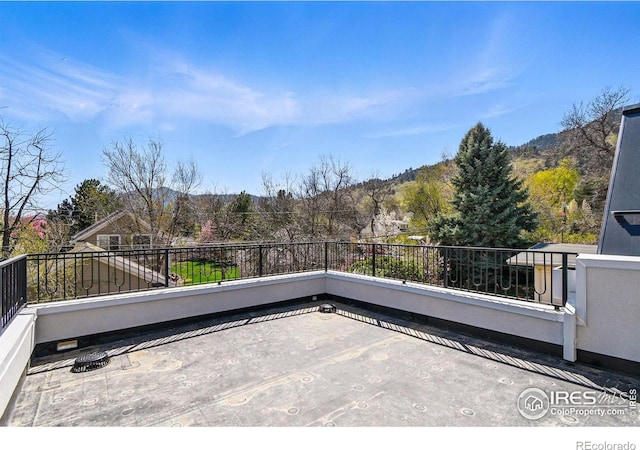view of patio / terrace with a mountain view and a balcony