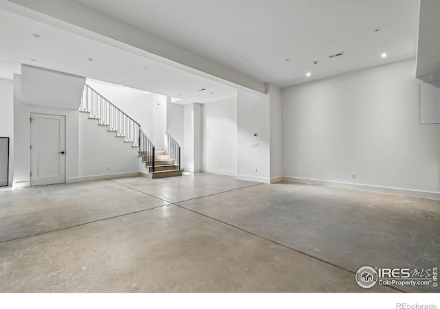 below grade area with recessed lighting, baseboards, and stairs
