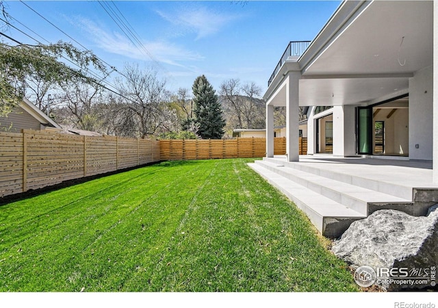 view of yard featuring a patio area and a fenced backyard