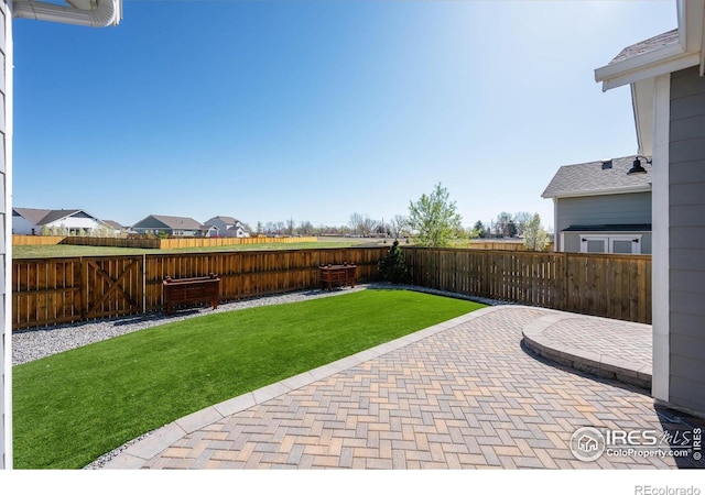 view of yard with a fenced backyard and a patio area