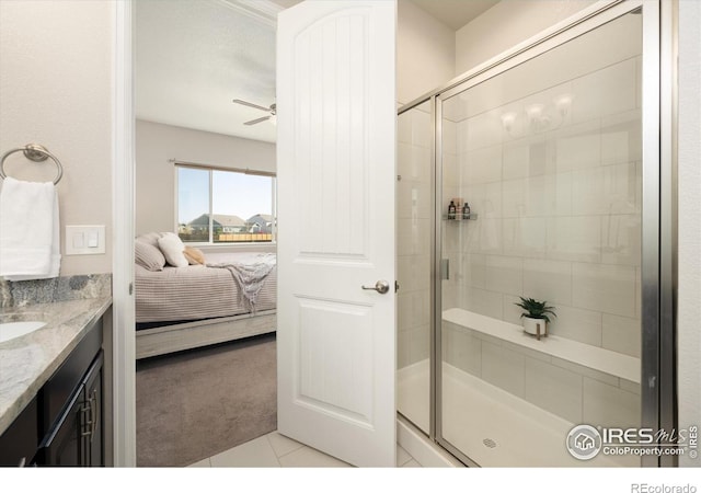 ensuite bathroom featuring vanity, ensuite bath, tile patterned floors, a ceiling fan, and a shower stall