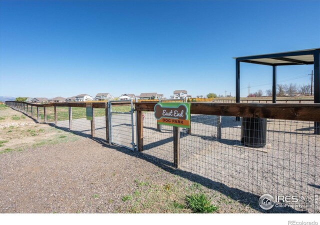 view of property's community with fence and a gate
