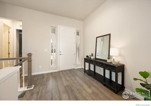 entryway with baseboards and wood finished floors