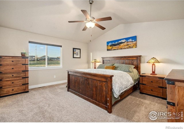 bedroom featuring ceiling fan, vaulted ceiling, carpet flooring, and baseboards