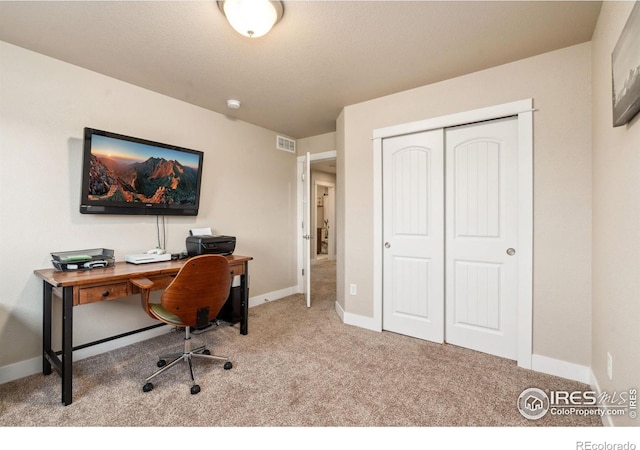 office area with visible vents, baseboards, and carpet flooring