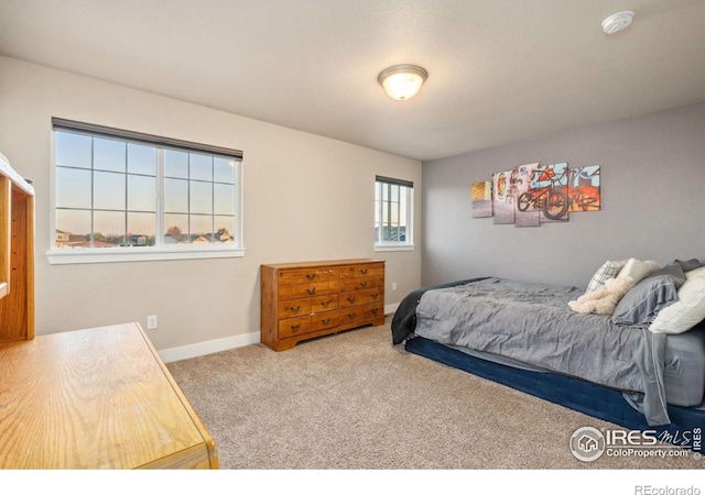 bedroom with carpet and baseboards
